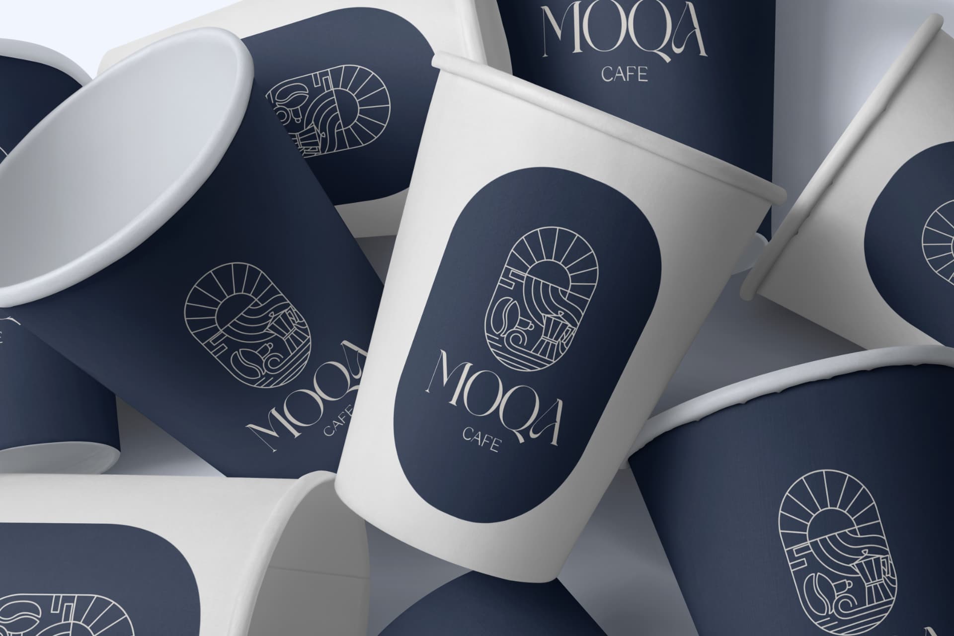 Moqa Cafe branded coffee cups with navy and white logo